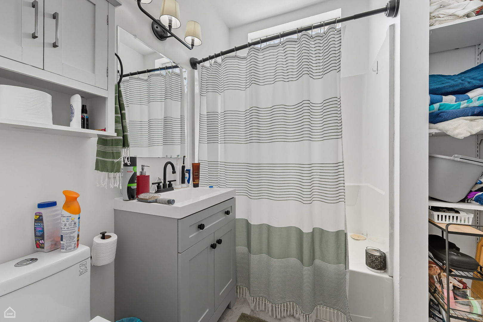 2245 West Erie Street Chicago, IL 60612 - Photo 22 of 25 a bathroom with a sink and a shower curtain