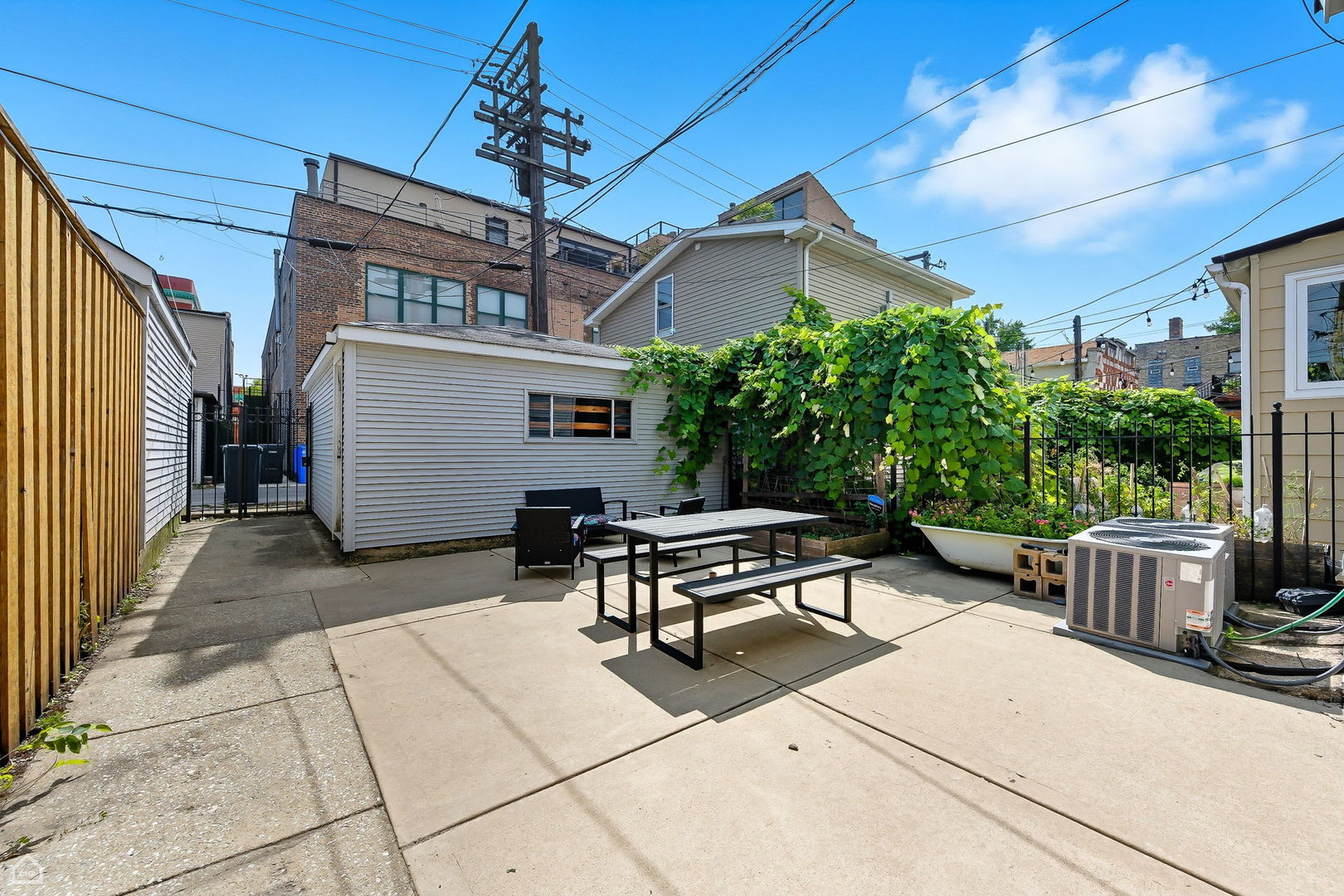 2245 West Erie Street Chicago, IL 60612 - Photo 23 of 25 a view of a patio with a table and chairs and potted plants