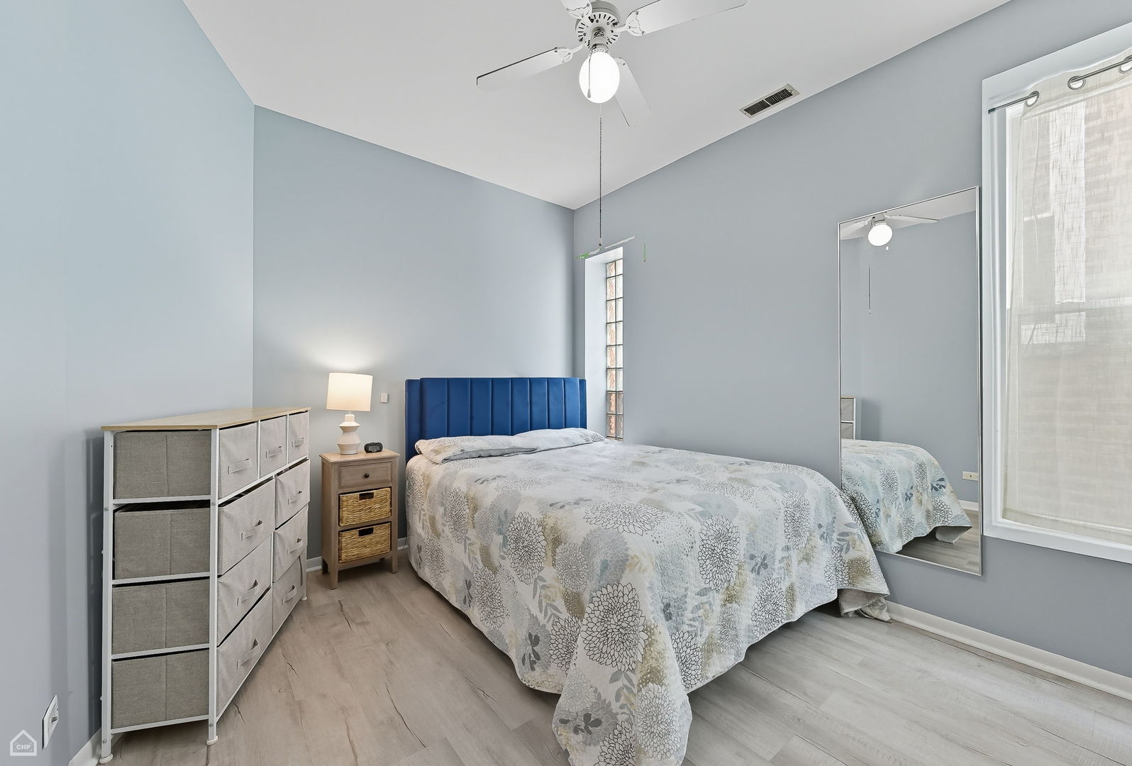 2245 West Erie Street Chicago, IL 60612 - Photo 10 of 25 a bedroom with a bed and a chandelier