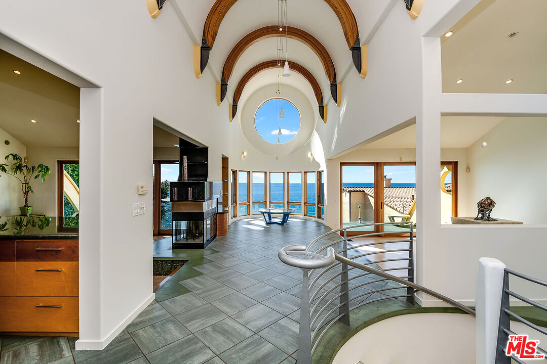 3930 Rambla Orienta Malibu, CA 90265 - Photo 1 of 30 a living room with fireplace furniture and a large window