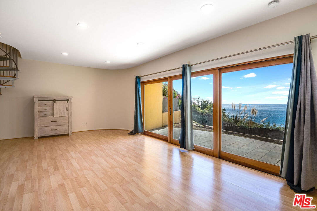 3930 Rambla Orienta Malibu, CA 90265 - Photo 26 of 30 a view of an empty room with wooden floor and a window