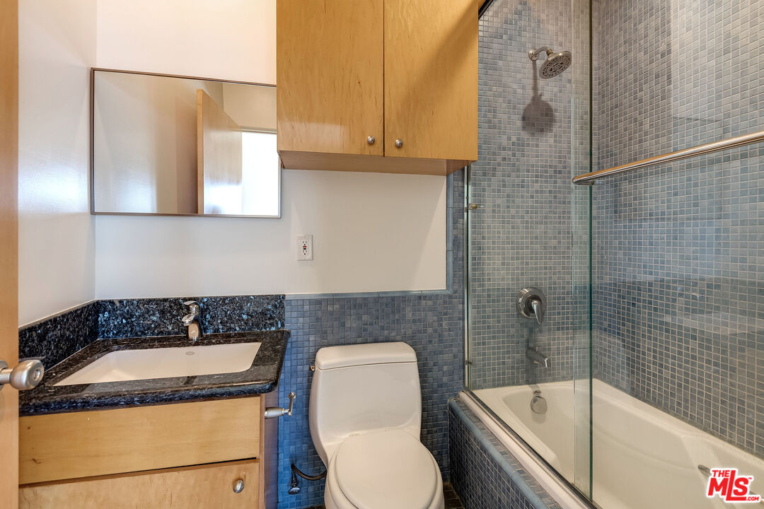 3930 Rambla Orienta Malibu, CA 90265 - Photo 27 of 30 a bathroom with a granite countertop sink toilet and shower