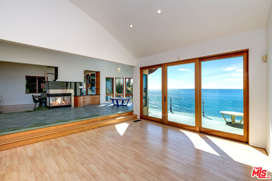 3930 Rambla Orienta Malibu, CA 90265 - Photo 6 of 30 a living room with a large window wooden floor