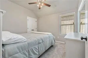 a bedroom with a bed and a large window