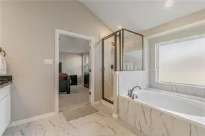 a bathroom with a tub and a sink