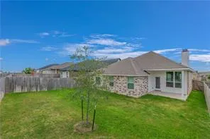 a view of a house with a yard and a garden
