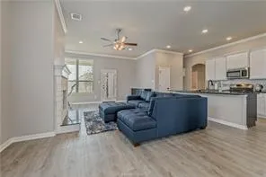a living room with furniture and a wooden floor