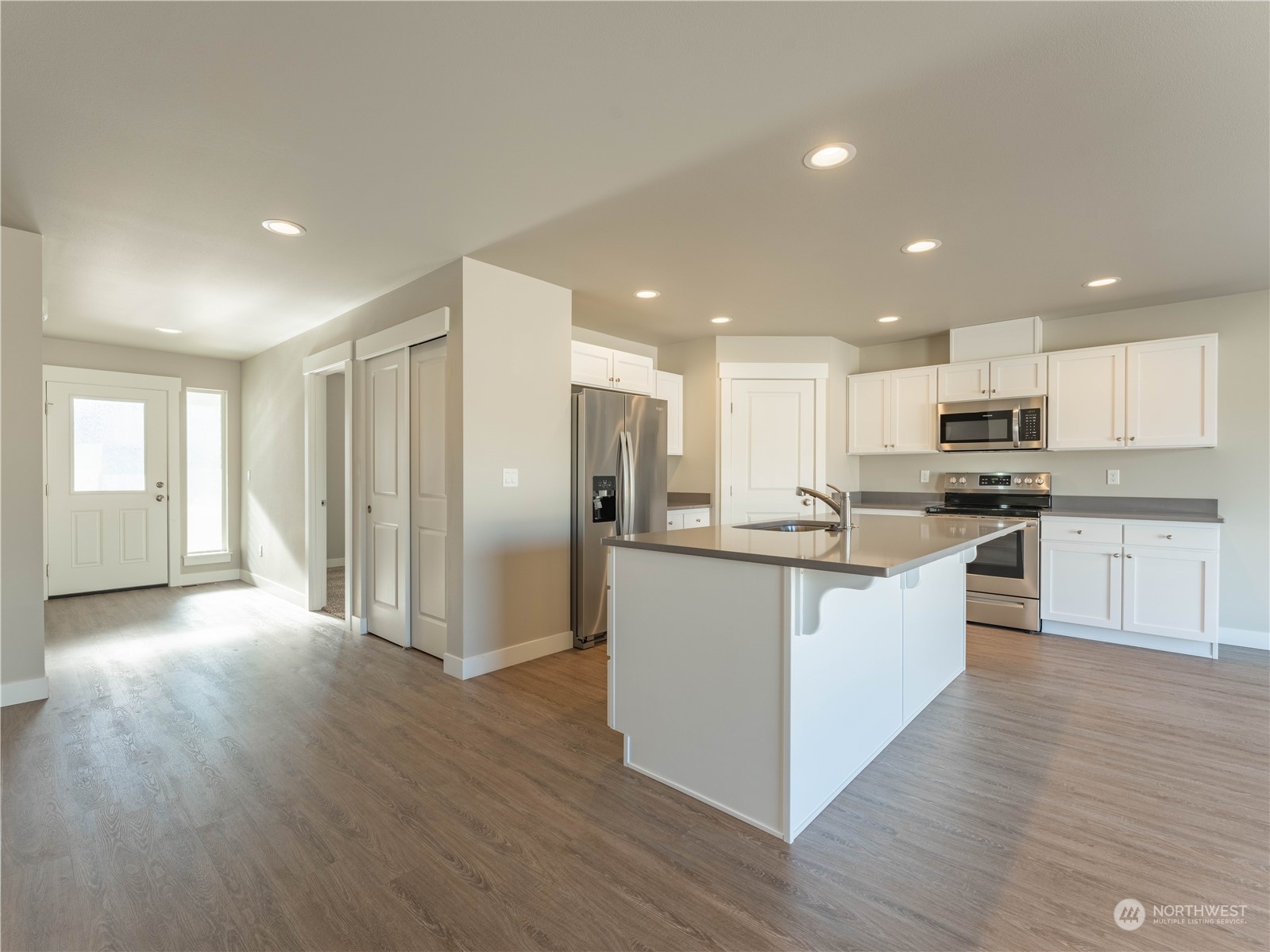 39 South Millbrook Loop East Wenatchee, WA 98802 - Photo 13 of 32 a kitchen with stainless steel appliances granite countertop a refrigerator a sink dishwasher a stove and white cabinets with wooden floor