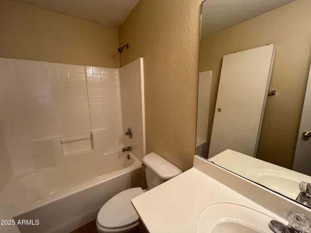 a bathroom with a toilet and a bath tub
