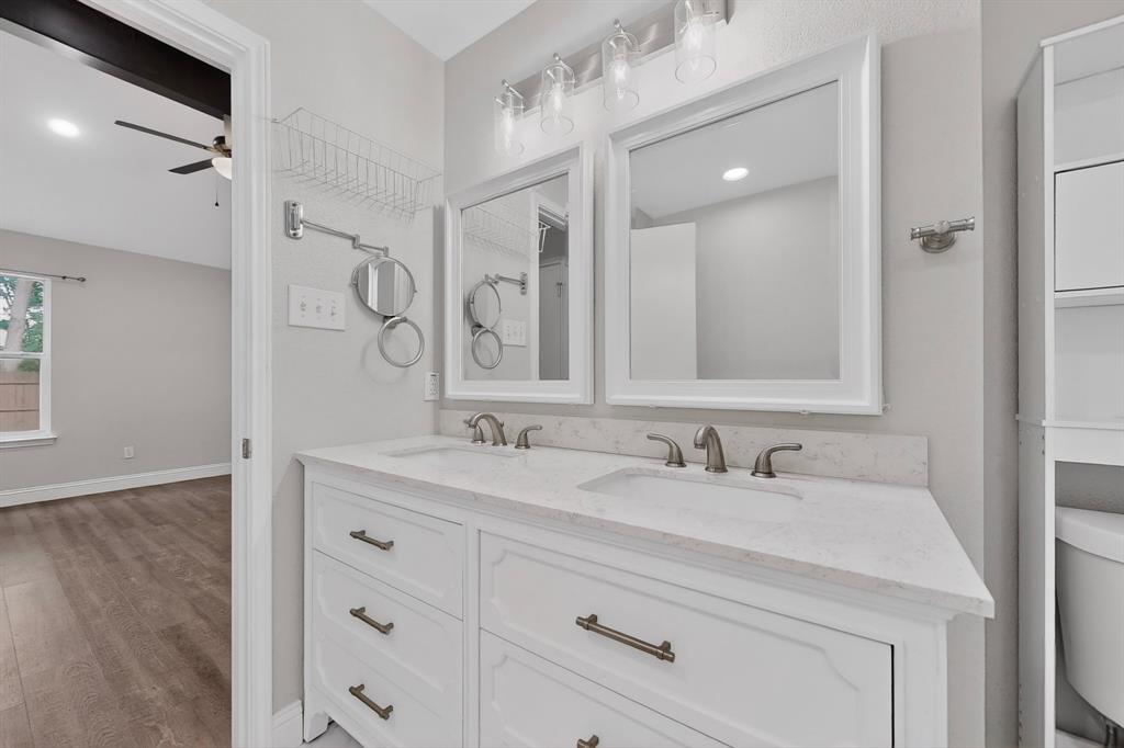7729 Misty Ridge Drive North Fort Worth, TX 76137 - Photo 15 of 30 a bathroom with a sink double vanity and a mirror