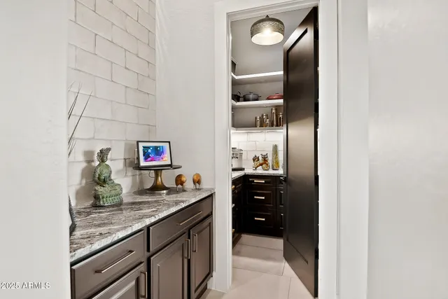 a spacious bedroom with a bed couch and a large window