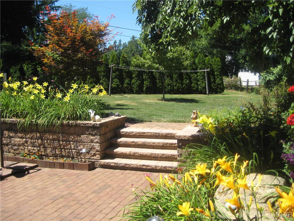4151 Shimerville Road Emmaus, PA 18049 - Photo 31 of 38 Brick patio and stairs to lush rear yard.