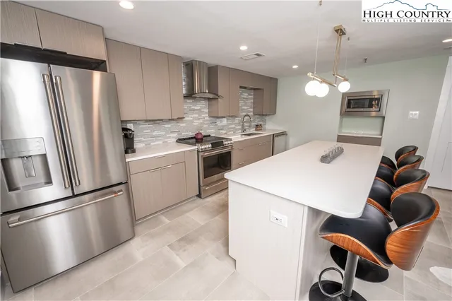 a kitchen with a sink stainless steel appliances and cabinets