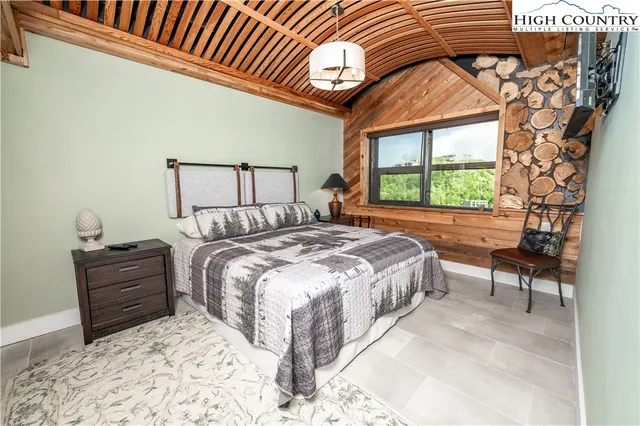 a bed sitting in a bedroom next to a window