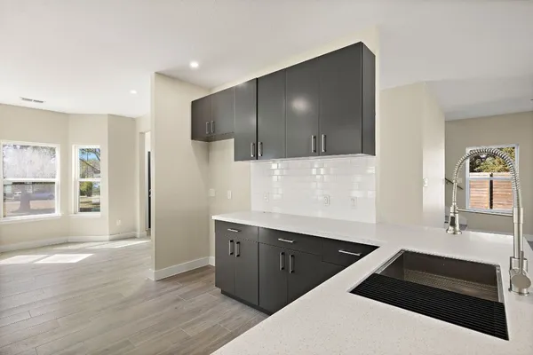 a kitchen with stainless steel appliances a sink stove and cabinets