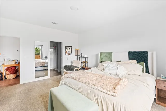 a bedroom with a bed and a couch