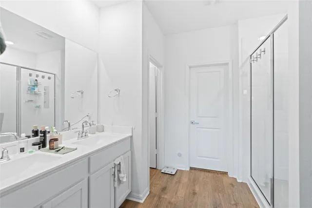 a spacious bathroom with a double vanity sink a mirror and a