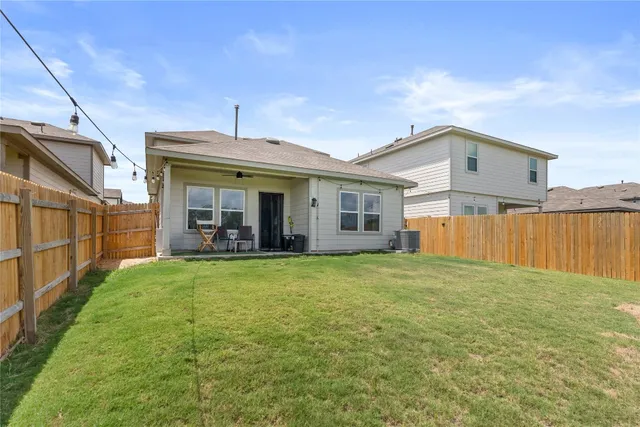 a view of a house with backyard and porch