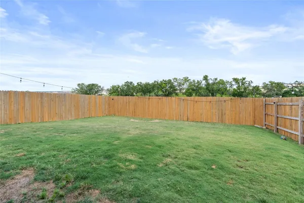 a view of a backyard with barn in the background