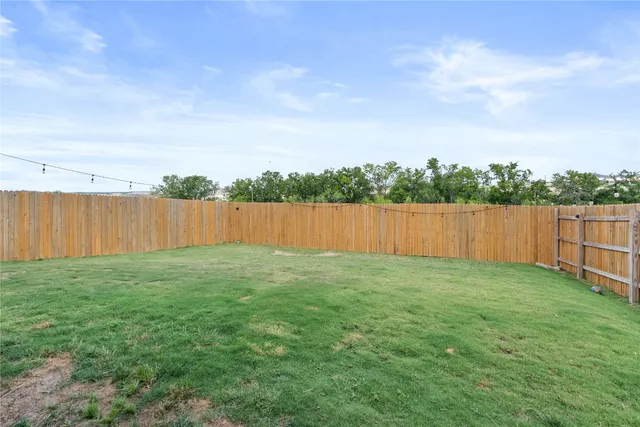 a view of a backyard with barn in the background