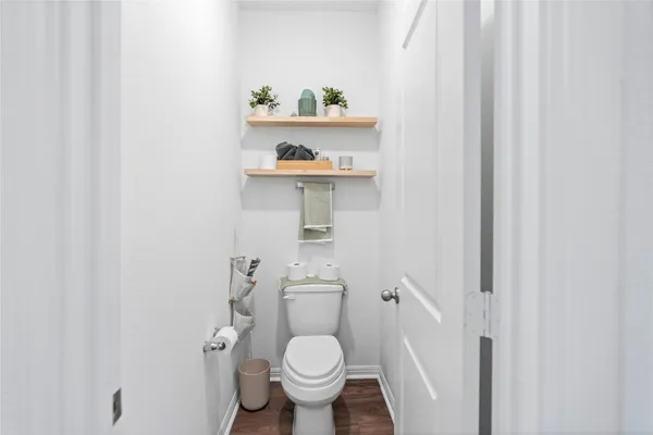 a white toilet sitting next to a bathroom sink