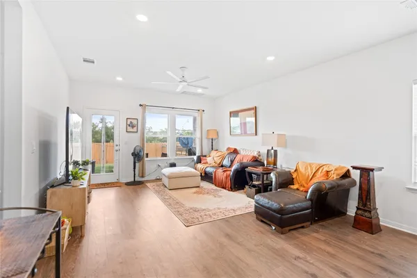 a living room with furniture and wooden floor