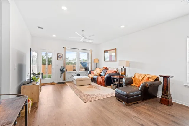 a living room with furniture and wooden floor