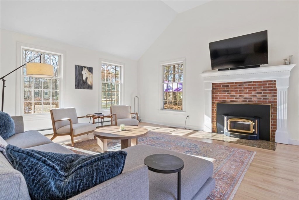 15 Fatherland Drive Newbury, MA 01922 - Photo 13 of 42 a living room with furniture a flat screen tv and a fireplace