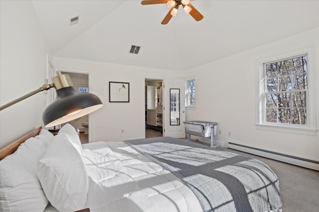 15 Fatherland Drive Newbury, MA 01922 - Photo 18 of 42 a bedroom with a bed and a chandelier