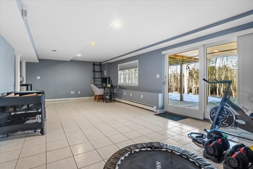 15 Fatherland Drive Newbury, MA 01922 - Photo 26 of 42 a spacious bedroom with a bed and a large window