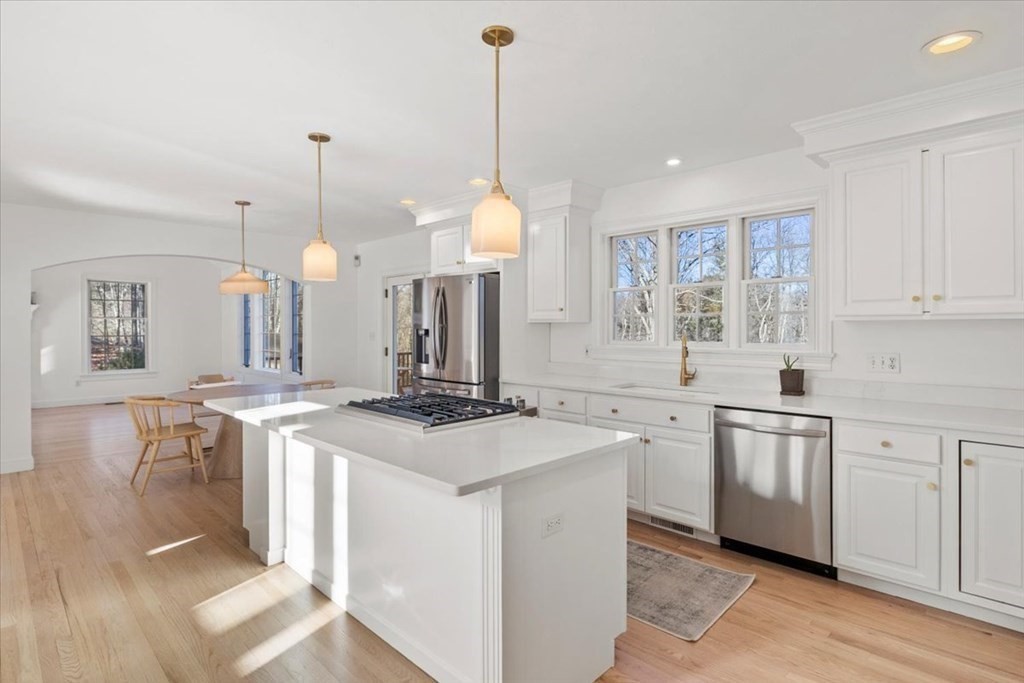15 Fatherland Drive Newbury, MA 01922 - Photo 8 of 42 a kitchen with a stove a sink a center island and a wooden floor