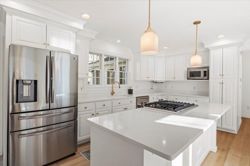15 Fatherland Drive Newbury, MA 01922 - Photo 9 of 42 a kitchen with stainless steel appliances granite countertop a refrigerator a sink dishwasher a stove and a refrigerator with wooden floor