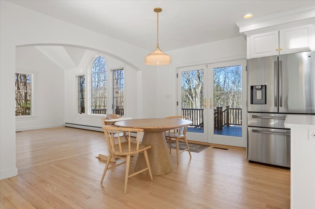 15 Fatherland Drive Newbury, MA 01922 - Photo 10 of 42 a dining room with wooden floor a chandelier a wooden table and chairs