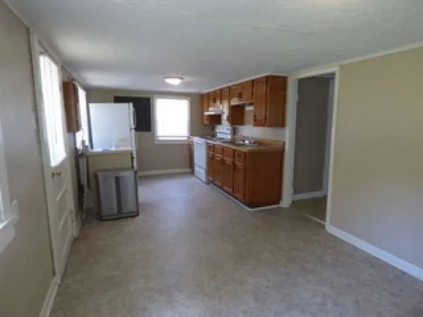 a kitchen with stainless steel appliances a refrigerator and a stove top oven