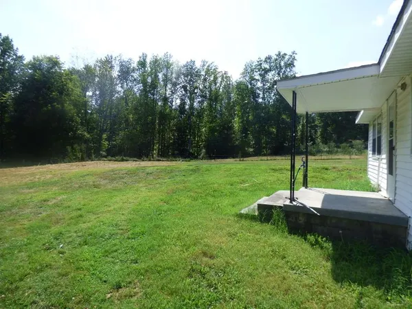 a backyard of a house with lots of green space