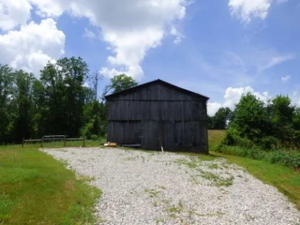 a wooden fence with some trees in the background
