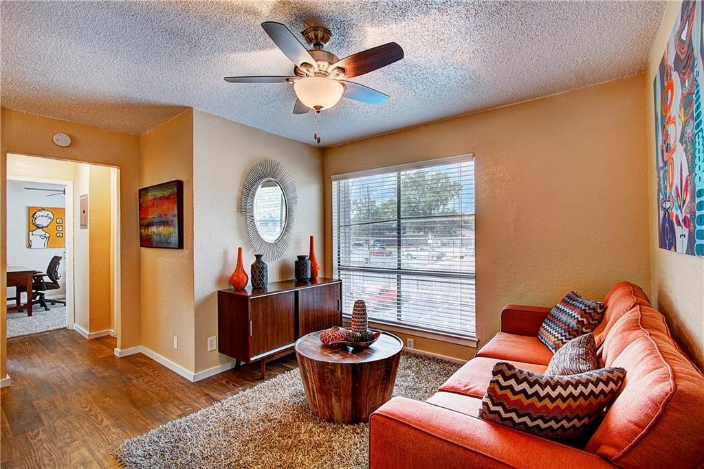 2401 Manor Road, Unit 224 Austin, TX 78722 - Photo 4 of 10 a living room with furniture a window and a chandelier