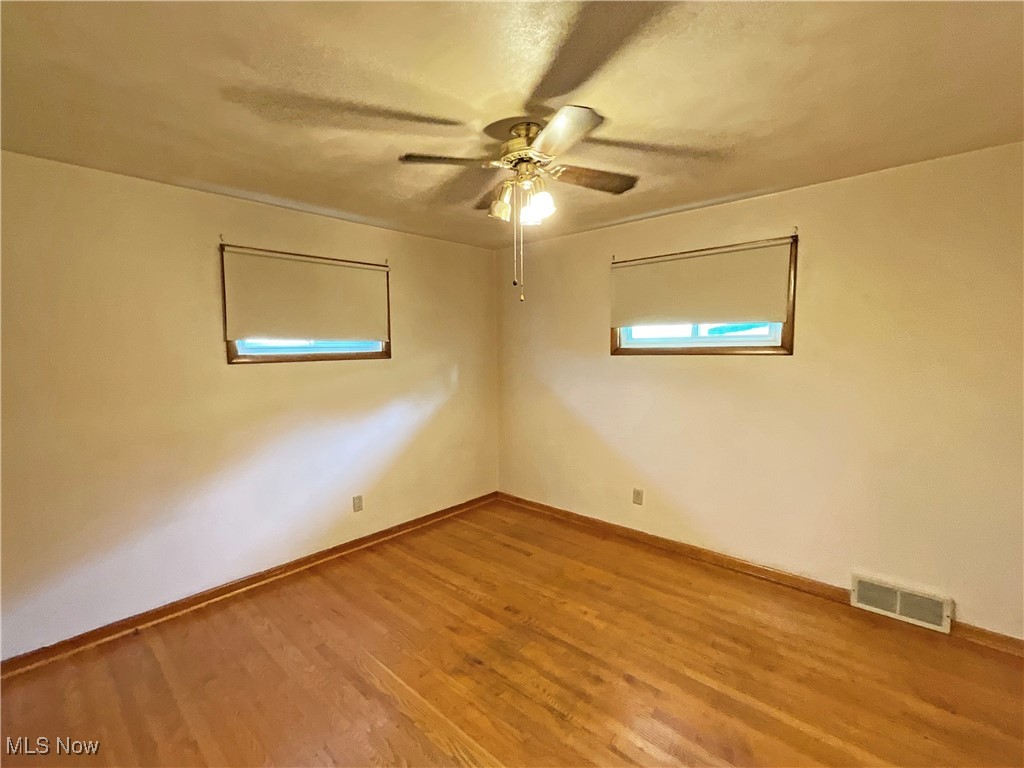 106 Ridgeway Avenue Weirton, WV 26062 - Photo 14 of 19 Unfurnished room featuring wood-type flooring and ceiling fan