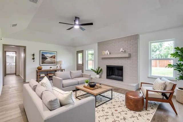 a living room with furniture a window and a fireplace