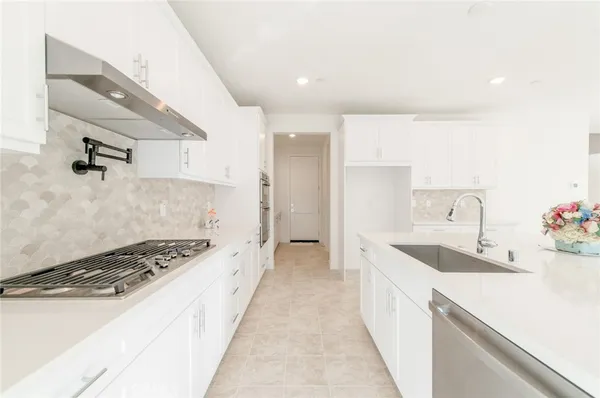 a kitchen with a sink and a stove top oven
