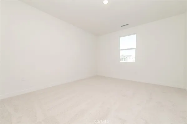 a view of an empty room and a window