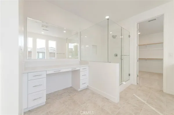 a bathroom with a shower sink and mirror