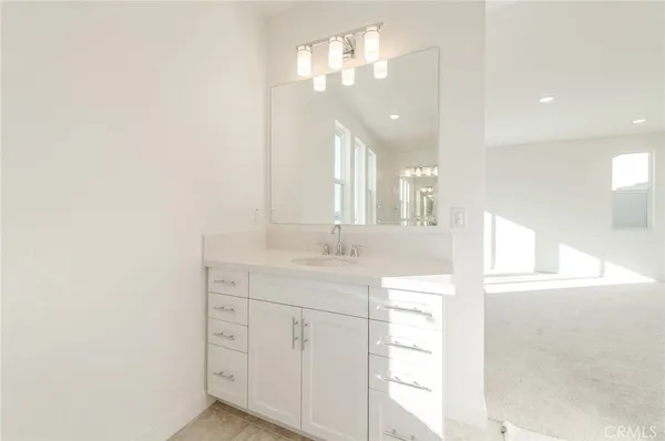 a bathroom with a sink a vanity and a mirror