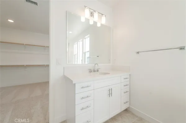 a bathroom with a sink vanity and a mirror
