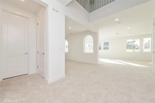 an empty room with windows and entrance