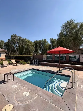 a view of a house with swimming pool and sitting area