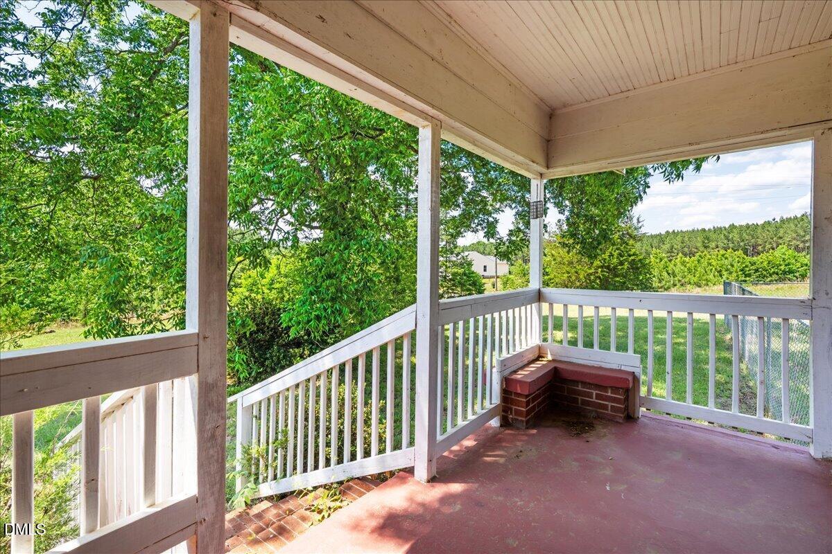109 Little Ponderosa Road Macon, NC 27551 - Photo 3 of 32 a view of a chair and table in the balcony