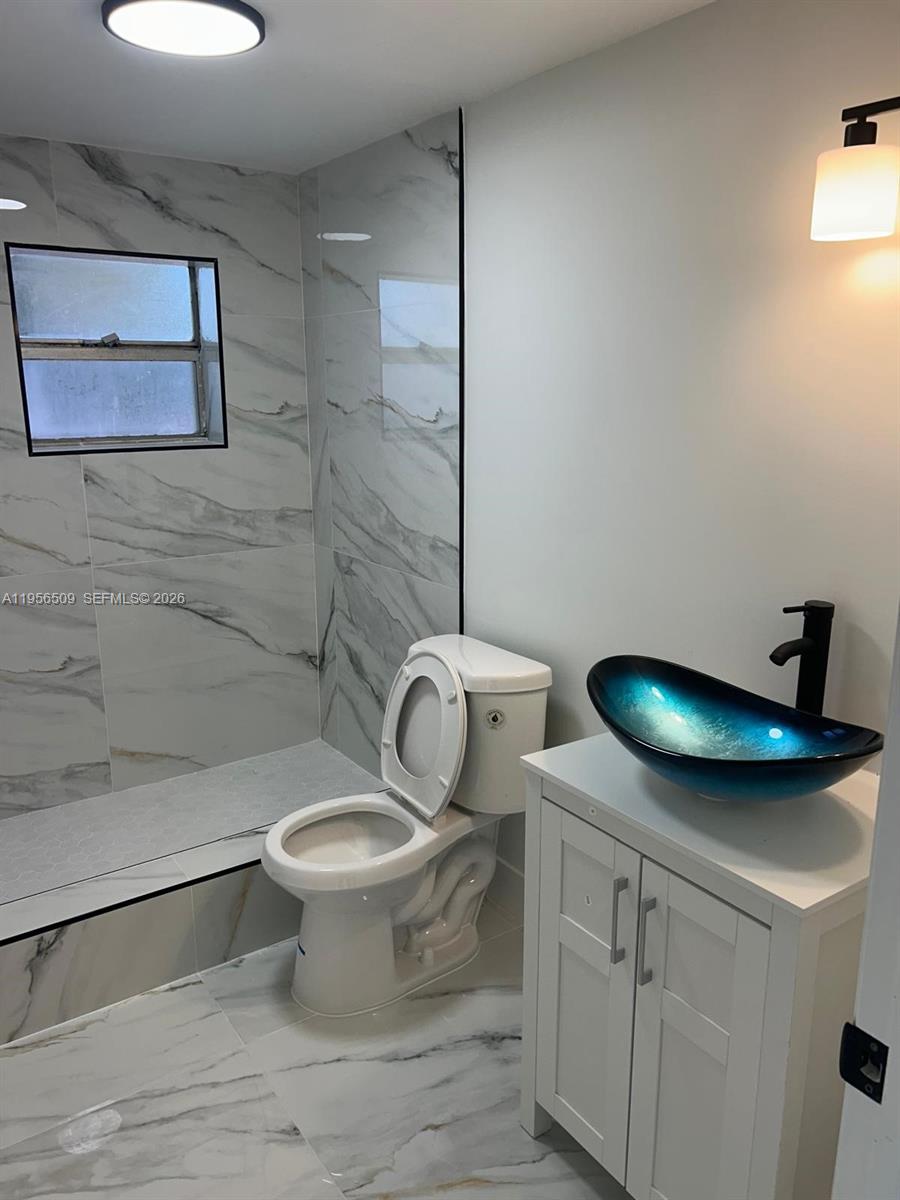 8600 Northwest 32nd Avenue Miami, FL 33147 - Photo 1 of 1 a bathroom with a toilet and a sink