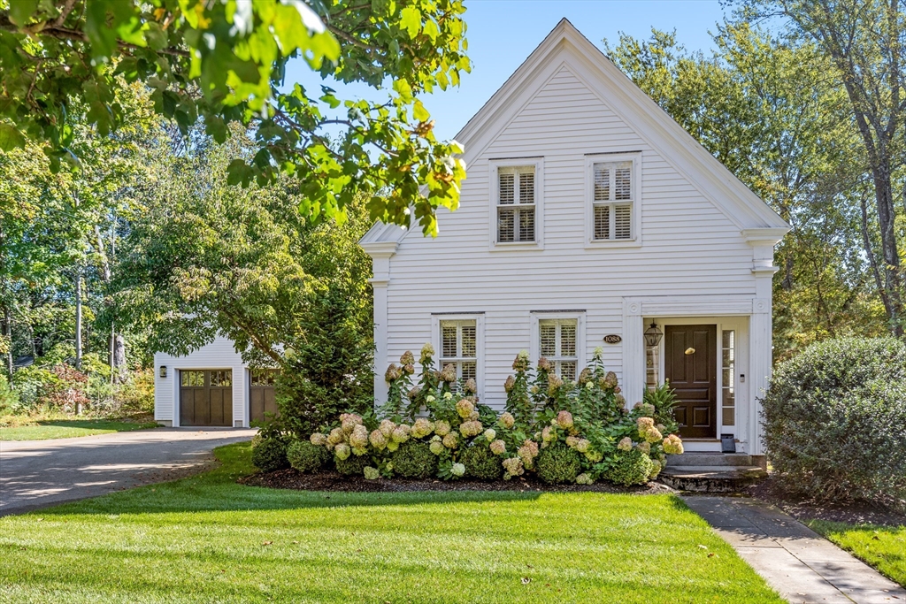 a front view of a house with a garden
