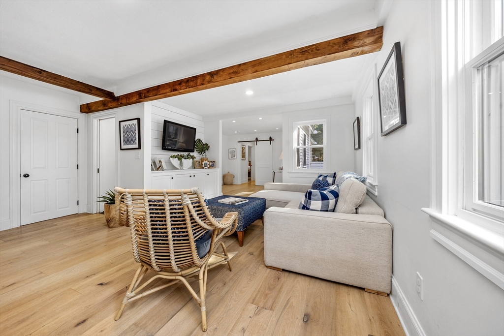 1088 Main Street Hingham, MA 02043 - Photo 12 of 37 a living room with furniture a flat screen tv and a wooden floor